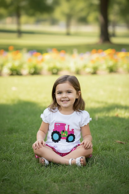 Pink Tractor printed on white ruffle top and pink shorts.