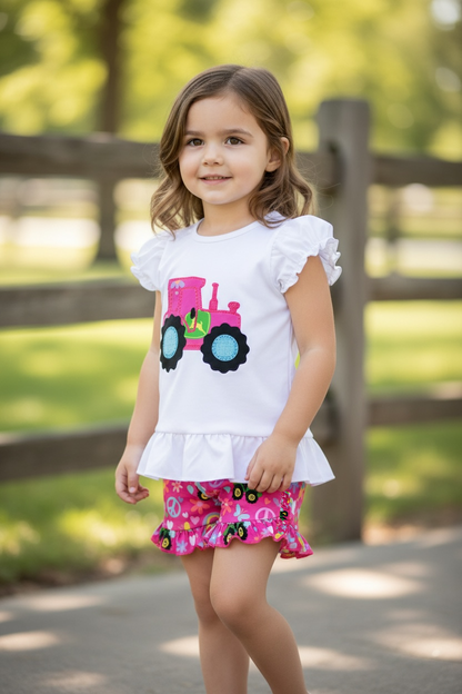 Pink Tractor printed on white ruffle top and pink shorts.